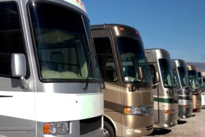 row of class A motorhomes in a line at a dealership