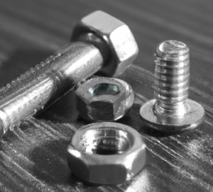 Two bolts and two nuts on a table